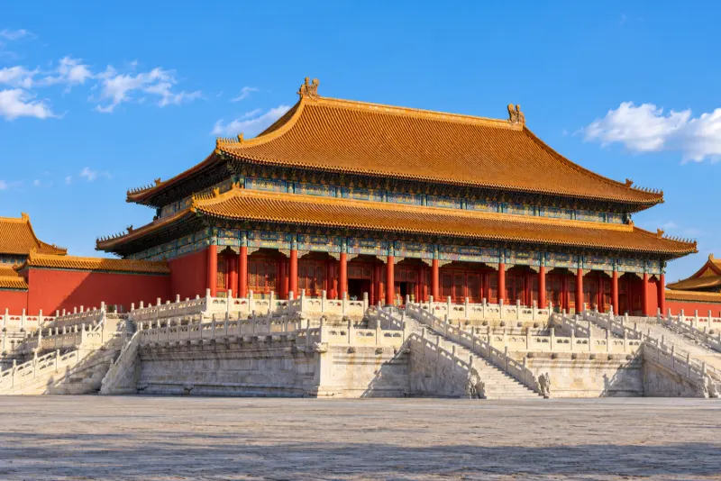 A red palace hall with golden roofs above white marble terraces in Beijing