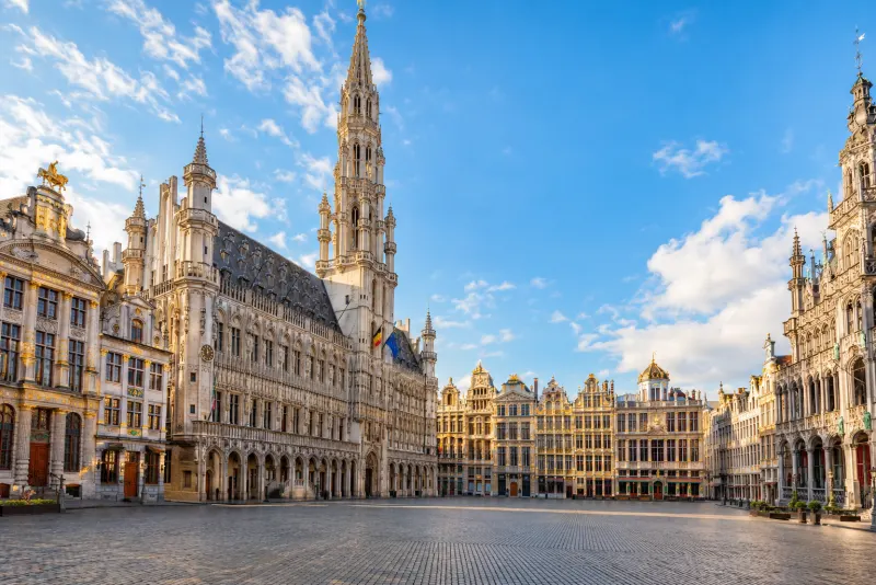 A grand square of gilded guild houses and a lace-like Gothic town hall spire in Brussels