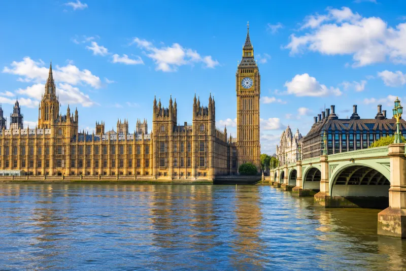 Big Ben and the Houses of Parliament beside the Thames on a bright day in London