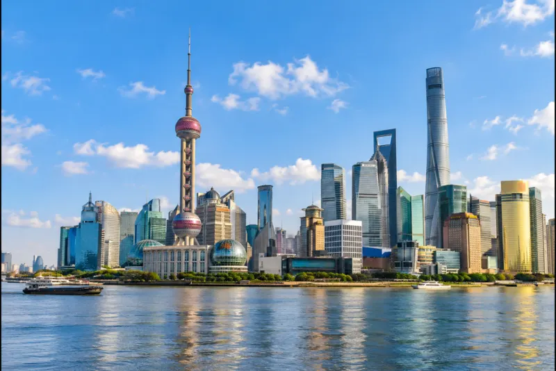 The Oriental Pearl Tower and glass skyscrapers across the river in Shanghai